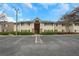 Apartment building with parking and manicured landscaping under a blue sky at 1468 Briarwood Ne Rd # 502, Brookhaven, GA 30319