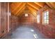 Exposed brick walls and wooden beams give this attic design a rustic, timeless, and spacious atmosphere at 218 Garland Ave, Decatur, GA 30030