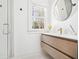 Modern bathroom featuring a sleek vanity, minimalist fixtures, a glass-enclosed shower, and white tile at 218 Garland Ave, Decatur, GA 30030