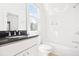 Modern bathroom with white subway tile, dark countertop, soaking tub and natural light at 218 Garland Ave, Decatur, GA 30030