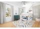 Bright bedroom features a white bunk bed, colorful rug, and natural light from large windows at 218 Garland Ave, Decatur, GA 30030