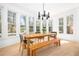 Sunlit dining room features large windows and a long wooden table, with chairs and a bench at 218 Garland Ave, Decatur, GA 30030