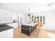 Modern kitchen with white cabinets, a marble-topped island, stainless steel appliances, and a connected dining area at 218 Garland Ave, Decatur, GA 30030