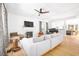 Bright living room features a fireplace, grand piano, and hardwood floors, seamlessly connecting to the kitchen at 218 Garland Ave, Decatur, GA 30030