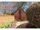 Brick outbuilding with wooden door, walkway, flowers, and landscaping at 218 Garland Ave, Decatur, GA 30030