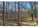 The backyard is a mix of trees, with direct access to a wooded area at 63 Colette Ct, Douglasville, GA 30134