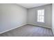 Cozy bedroom featuring neutral carpet and natural lighting at 63 Colette Ct, Douglasville, GA 30134