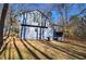 Exterior view of the blue home showing a newly constructed back deck and the surrounding wooded area at 63 Colette Ct, Douglasville, GA 30134