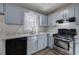 Charming kitchen featuring stainless steel appliances, stone countertops, and light blue cabinets at 63 Colette Ct, Douglasville, GA 30134