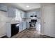 Charming kitchen featuring stainless steel appliances, stone countertops, and light blue cabinets at 63 Colette Ct, Douglasville, GA 30134