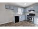 Charming kitchen featuring stainless steel appliances, stone countertops, and light blue cabinets at 63 Colette Ct, Douglasville, GA 30134