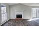 Spacious living room featuring a fireplace and large windows that fill the space with natural light at 63 Colette Ct, Douglasville, GA 30134