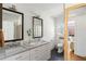 Bright bathroom with double sink vanity, granite countertop, and black hexagon tile flooring at 1328 Briarwood Ne Dr, Atlanta, GA 30306