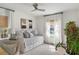 Bright bedroom featuring a daybed with many pillows, neutral decor, a ceiling fan, and a large window at 1328 Briarwood Ne Dr, Atlanta, GA 30306