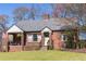 Charming brick home with a covered porch and well-maintained front lawn at 1328 Briarwood Ne Dr, Atlanta, GA 30306