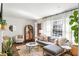 Sun-filled living room featuring hardwood floors, a cozy sectional, and modern decor at 1328 Briarwood Ne Dr, Atlanta, GA 30306