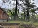 Fenced backyard with mature trees around the perimeter of the home at 3095 Rainbow Dr, Decatur, GA 30034