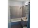 A full bathroom with a tiled shower-tub and built in vanity at 3095 Rainbow Dr, Decatur, GA 30034