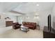 Finished basement with a seating arrangement, including a sofa, chair and table at 3841 Admiral Dr, Atlanta, GA 30341