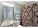 Well-lit bathroom features tiled shower with decorative shower curtain and a stylish vanity at 3841 Admiral Dr, Atlanta, GA 30341