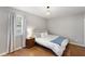 Comfortable bedroom with hardwood floors, neutral tones, and natural light from a large window at 3841 Admiral Dr, Atlanta, GA 30341