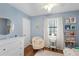 ' bedroom with blue walls, built in bookshelves, and a comfortable place to read a book at 3841 Admiral Dr, Atlanta, GA 30341