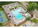 Aerial view of community pool with ample seating, umbrellas, and adjacent tennis courts at 3841 Admiral Dr, Atlanta, GA 30341