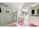 Bright bathroom with a glass shower, standalone tub, marble floors, and granite counters at 93 Carriage Lake Dr, Stockbridge, GA 30281