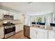 Well-lit kitchen featuring granite countertops, stainless steel appliances, and white cabinetry at 93 Carriage Lake Dr, Stockbridge, GA 30281