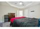 Main bedroom with a trey ceiling and neutral walls, with an adjoining bathroom at 93 Carriage Lake Dr, Stockbridge, GA 30281