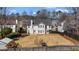 Large, fenced backyard, with trees, and a two-story home in background at 3521 Kittery Dr, Snellville, GA 30039