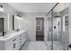 Bathroom featuring new tiling, double vanity, and frameless glass shower at 3521 Kittery Dr, Snellville, GA 30039