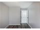 Minimalist bedroom featuring wood floors and a view into the kitchen at 3521 Kittery Dr, Snellville, GA 30039