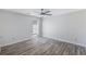 Minimalist bedroom with gray walls, wood-look floors, and ceiling fan at 3521 Kittery Dr, Snellville, GA 30039