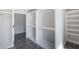 Walk-in closet with custom white shelves and wood-look floors at 3521 Kittery Dr, Snellville, GA 30039