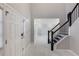 Bright foyer features white marble floors and stairway with black railings at 3521 Kittery Dr, Snellville, GA 30039