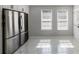 Bright kitchen with stainless steel refrigerator, white cabinets and marble floors at 3521 Kittery Dr, Snellville, GA 30039