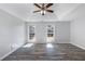 Large main bedroom with trey ceiling, wood-look flooring and bright windows at 3521 Kittery Dr, Snellville, GA 30039