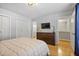 Bedroom with hardwood floors, a large closet, neutral walls, and a door leading to the bathroom at 566 Trillum Sw Ct, Marietta, GA 30008