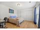 Bedroom featuring wood floors, neutral paint, a desk, and double closets at 566 Trillum Sw Ct, Marietta, GA 30008