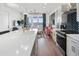 Modern open-concept kitchen with quartz countertops, an island bar, and stainless steel appliances at 989 Bibbs Circle Nw, Atlanta, GA 30318