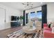 Living room showcasing large windows, ample natural light, stylish furniture, and LVP flooring at 989 Bibbs Circle Nw, Atlanta, GA 30318