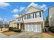 Charming two-story home featuring a stone accented garage and inviting blue shutters and trim against a blue sky at , Atlanta, GA 30318