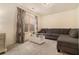 Comfortable living room with gray sofa, neutral carpet, side table, and natural light streaming through the window at , Atlanta, GA 30318