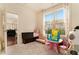 Bright ' playroom featuring a large window, neutral carpet, and a -sized table and chairs at , Atlanta, GA 30318