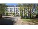 Modern multi-story apartment building with balconies, landscaping, and sidewalk at 234 Carlyle Park Ne Dr # 234, Atlanta, GA 30307