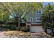 Charming two-story home with a brick garage and a well-manicured front yard surrounded by mature trees at 234 Carlyle Park Ne Dr # 234, Atlanta, GA 30307