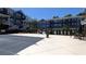 Outdoor pool with furniture surrounded by green shrubbery and blue condominium buildings at 234 Carlyle Park Ne Dr # 234, Atlanta, GA 30307