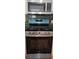 Close-up of a modern stainless steel range with an overhead microwave, complemented by a tile backsplash at 234 Carlyle Park Ne Dr # 234, Atlanta, GA 30307
