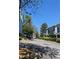 Exterior street view of homes with well-kept landscaping and mature trees on a sunny day at 234 Carlyle Park Ne Dr # 234, Atlanta, GA 30307